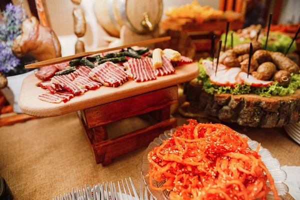 Jídelní stůl s různými jídly občerstvení a předkrmy — Stock fotografie
