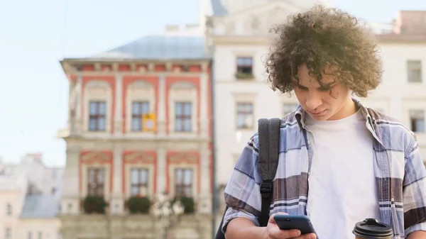 Şehirde Kahve Ile Bir Akıllı Telefon Kullanan Genç Adam — Stok fotoğraf