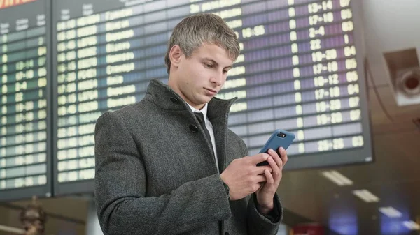 Handsome businessman in a city. Portrait of handsome business man using smartphone  in the city.