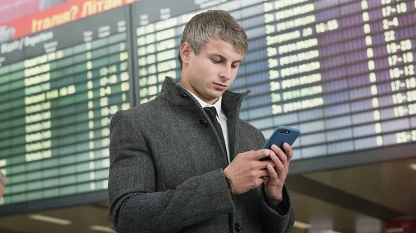 Handsome businessman in a city. Portrait of handsome business man using smartphone  in the city.