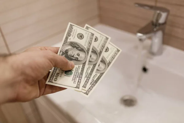 stock image money of american dollars in male hand.