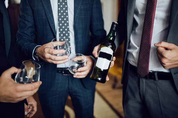 Men with glasses of whiskey. whiskey close up.