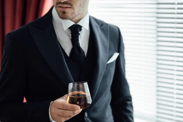 groom with glass of whiskey. whiskey close up.