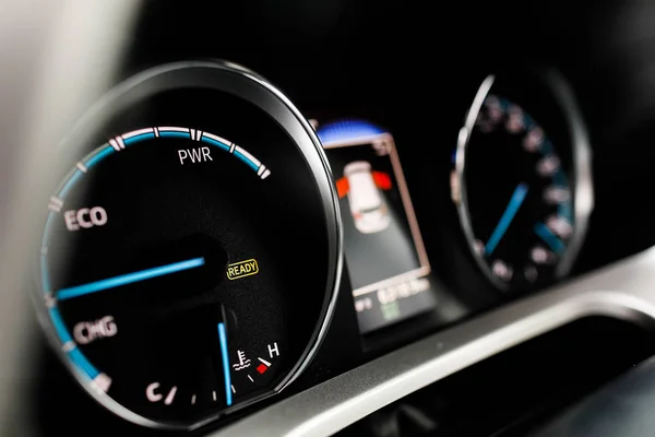 Hybrid car dashboard speedometer tachometer with full energy level. Digital dashboard of a modern car.