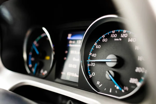 Hybrid car dashboard speedometer tachometer with full energy level. Digital dashboard of a modern car.