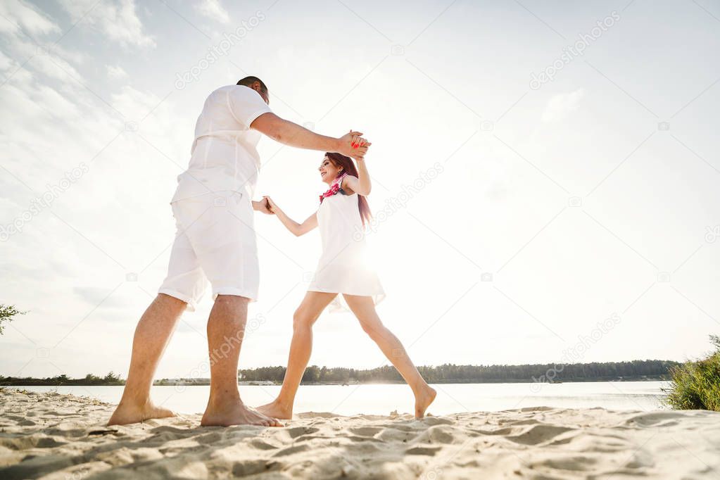 Sunny summer day. Happy couple smiling at the beach