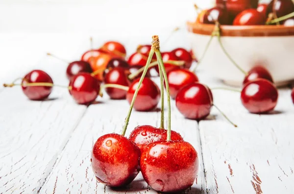 Healthy eating concept. Healthy  sweet cherries on wooden white background.