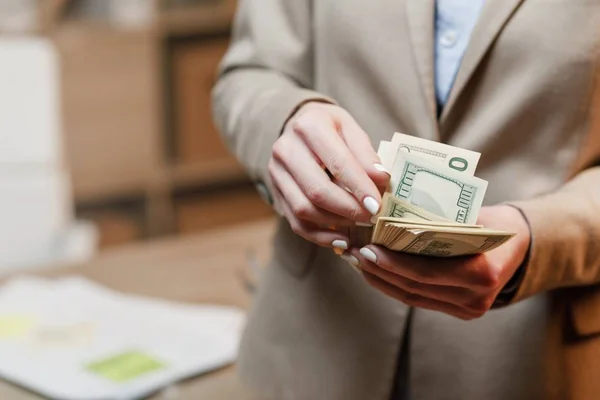 Businesswoman with cash. Hand holding dollar money.