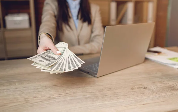 Close up of woman with money. Businesswoman holding cash. Hand giving money.  Businesswoman in eyeglasses holding dollar currency.