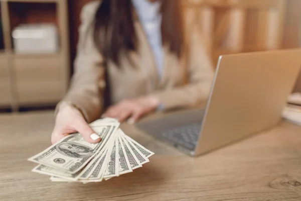 Close up of woman with money. Businesswoman holding cash. Hand giving money.  Businesswoman in eyeglasses holding dollar currency.