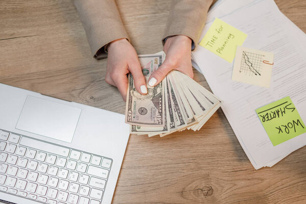 Businesswoman with cash. Hand holding dollar money.