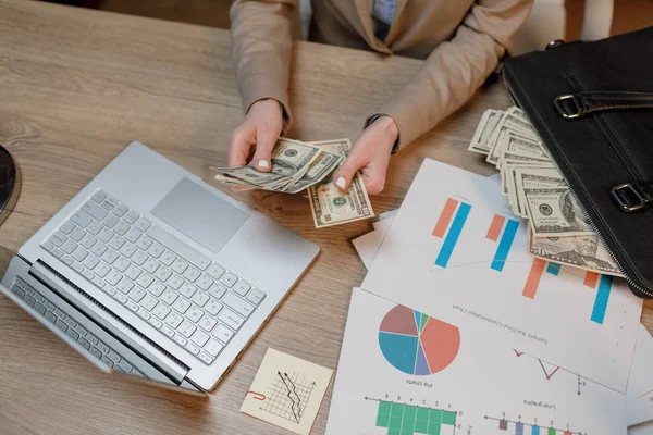 Close up of woman with money. Businesswoman holding cash. Hand giving money.