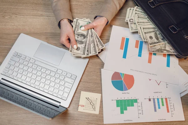 Close up of woman with money. Businesswoman holding cash. Hand giving money.