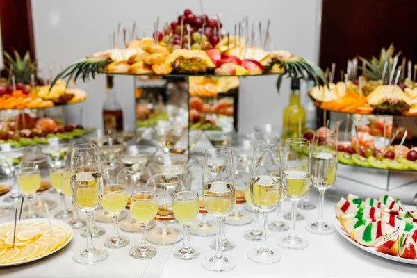 Sparkling wine. Champagne glasses. Delicious sweet buffet with cupcakes sparkling wine in party.