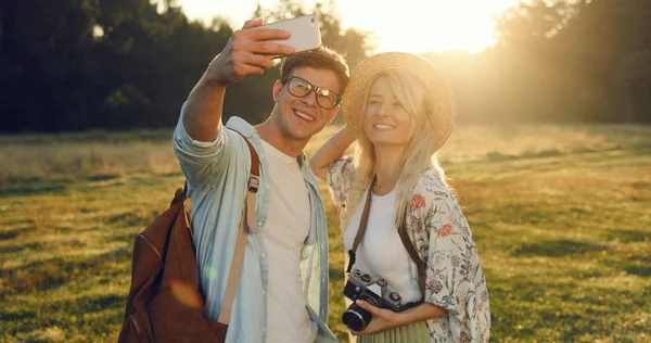 Happy Travel couple making selfie portrait with smartphone.