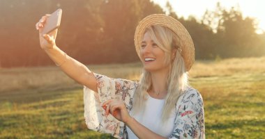 Cep telefonu ile selfie alma şapka neşeli genç kız.