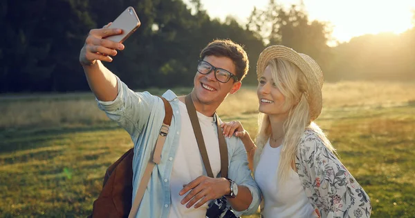 Happy Travel couple making selfie portrait with smartphone.