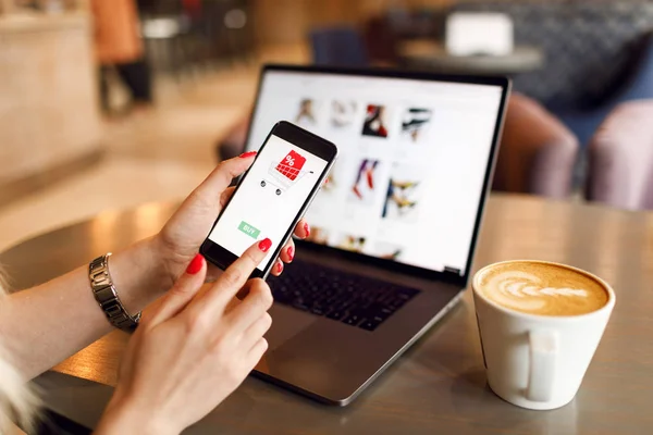 Online Shopping Concept. Online payment. Woman hands using smartphone and laptop computer for online shopping. Payment Detail page display.