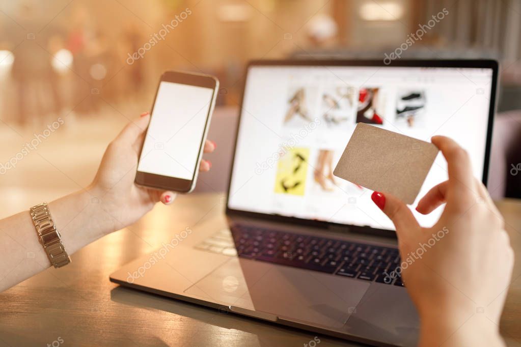 Online Shopping Concept. Online payment. Woman hands using smartphone and laptop computer for online shopping. Payment Detail page display.