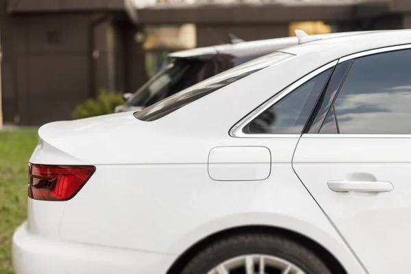 New modern sports car.  Back lights of white car. Closeup of car tail light on a white car.