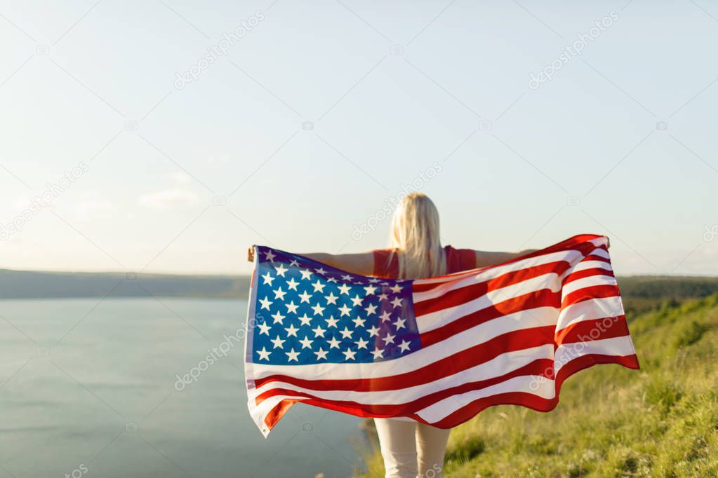 American flag. Young woman holding USA flag for freedom concept. 4th of July, Independence day.