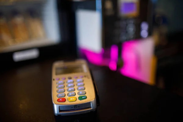 Credit card machine with bokeh background