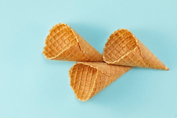 Ice cream waffle cones on blue Background. Minimal composition. Top view. Flat lay.
