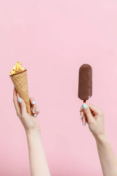 Woman holding Ice Cream on a pink background. Copy space.