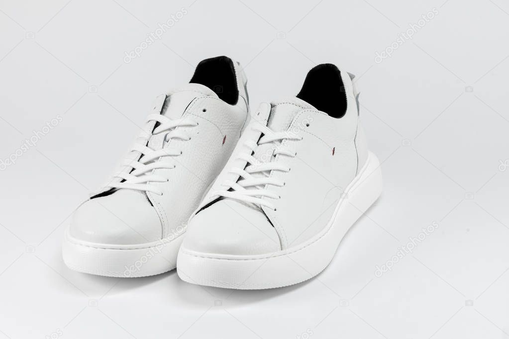 Mens sport shoes, close up. New white sneakers 
