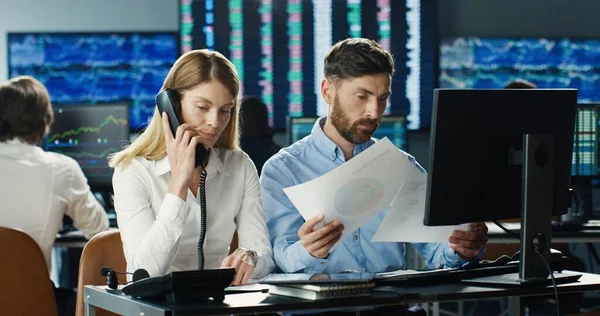 Portrait of traders and brokers working at stock exchange office. Monitors Display Relevant Infographics, Data and Numbers. Global Financial Concept
