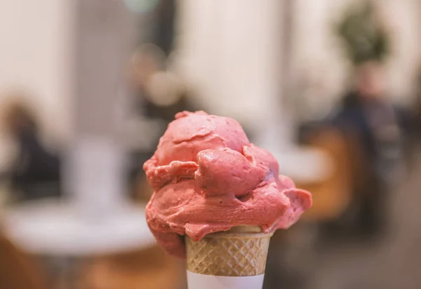 Close-up pink fruit ice cream on blurred background
