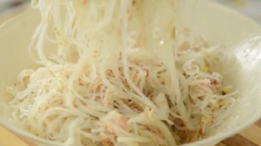 man cooking tuna and noodles salad