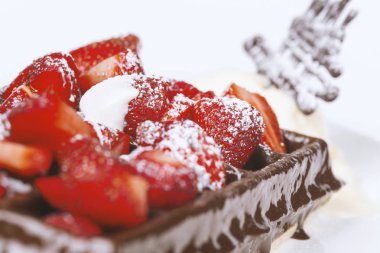 Dondurma, koyu çikolata ve beyaz arka plan üzerinde çilek ile Belçika waffle