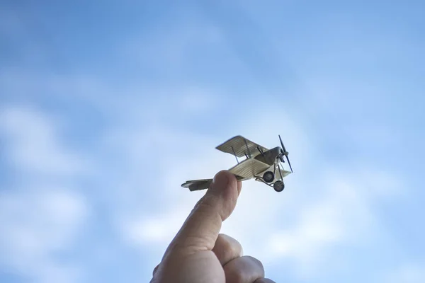 Airplane toy with lens flare against blue sky
