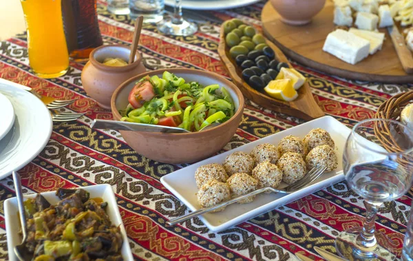 Starters and appetizers on clay and wooden plates in Middle East — Stock Photo, Image