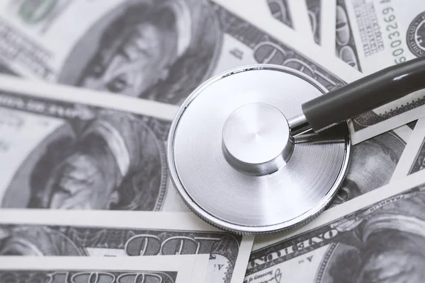 Dollars with stethoscope on them. Costs for the medical insurance