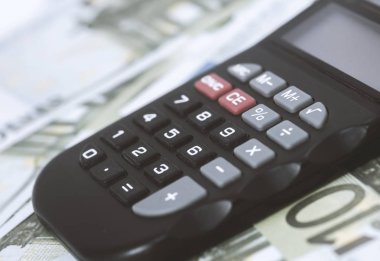 Birkaç Euro ve masada bir hesap makinesi, finans ve tasarruf. İş konsepti