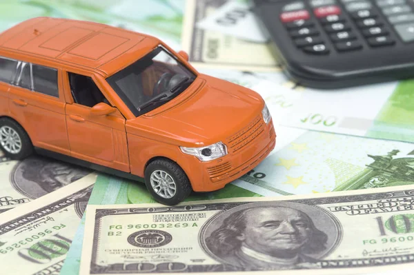 orange car and money, euro and dollars. insurance concept