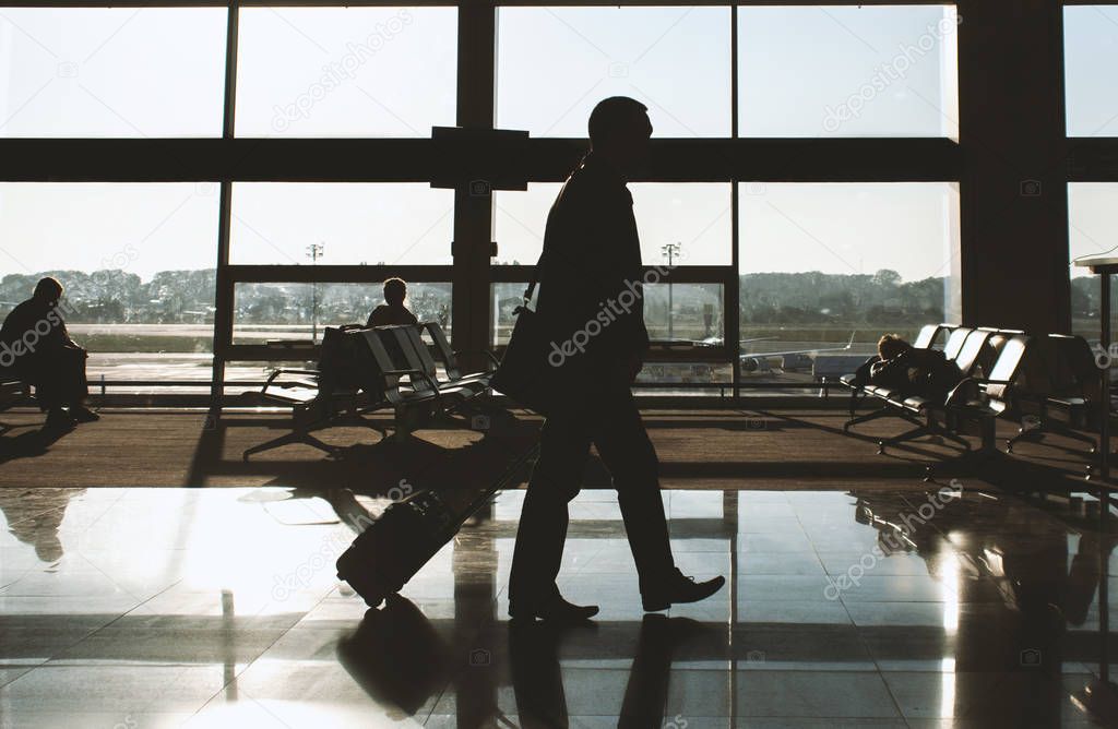 silhouettes of passengers at the airport. travel concept