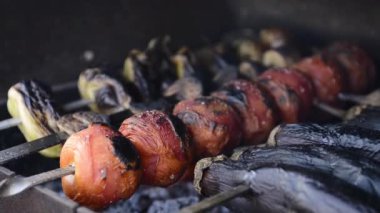 Barbecue with delicious grilled vegetables cooked on the grill.Eggplants , tomatoes and bell peppers are fried on coals.