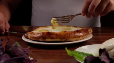 Man eat oriental dish. Adjarian khachapuri. Georgian  food