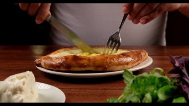 Man eat oriental dish. Adjarian khachapuri. Georgian  food