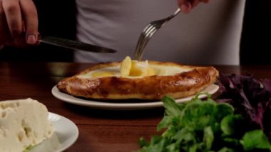 Man eat oriental dish. Adjarian khachapuri. Georgian  food