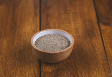 Ahşap bir masada seramik tuz ve biber kapları.