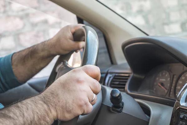 Man driving a car. The person drives a car in Europe or USA