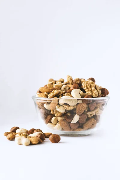 Mixed nuts in a bowl on a white background. — Stock Photo, Image