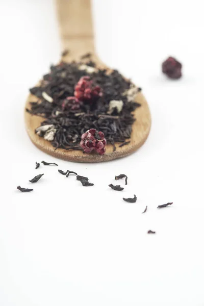 Aromatischer Schwarzer Trockener Tee Mit Himbeeren Auf Einem Holzlöffel Isoliert — Stockfoto