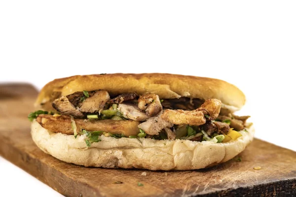 oriental sandwich shawarma, doner kebab, gyros on a wooden table on white background