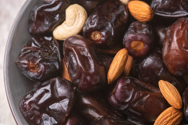 Beyaz ahşap arka planda fındık ve hurma karışımı. Üst görünüm. Sağlıklı yemek.