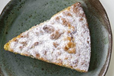 Beyaz ahşap masada seramik tabakta lezzetli bir turta.